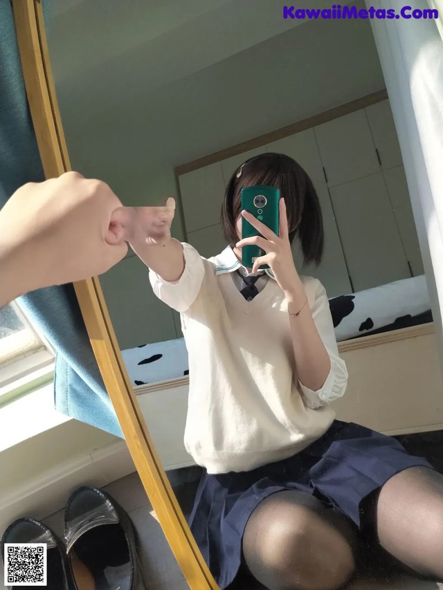 A woman taking a picture of herself in a mirror.