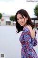 A woman in a blue dress posing for a picture.