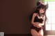 Anime girl in a black bikini sitting on the floor.