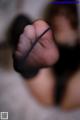 A close up of a woman's feet in black stockings.